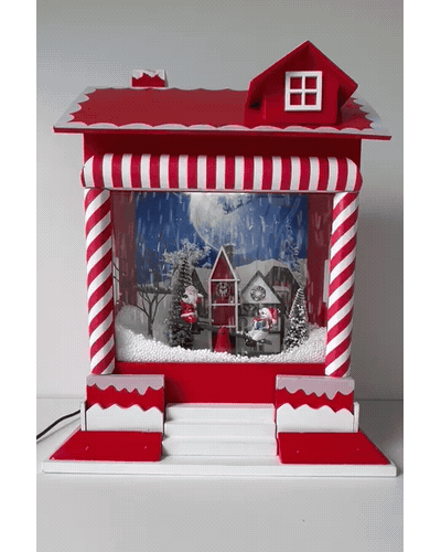 Villa Nevada: casita navideña con su escena iluminada y nieve en movimiento.